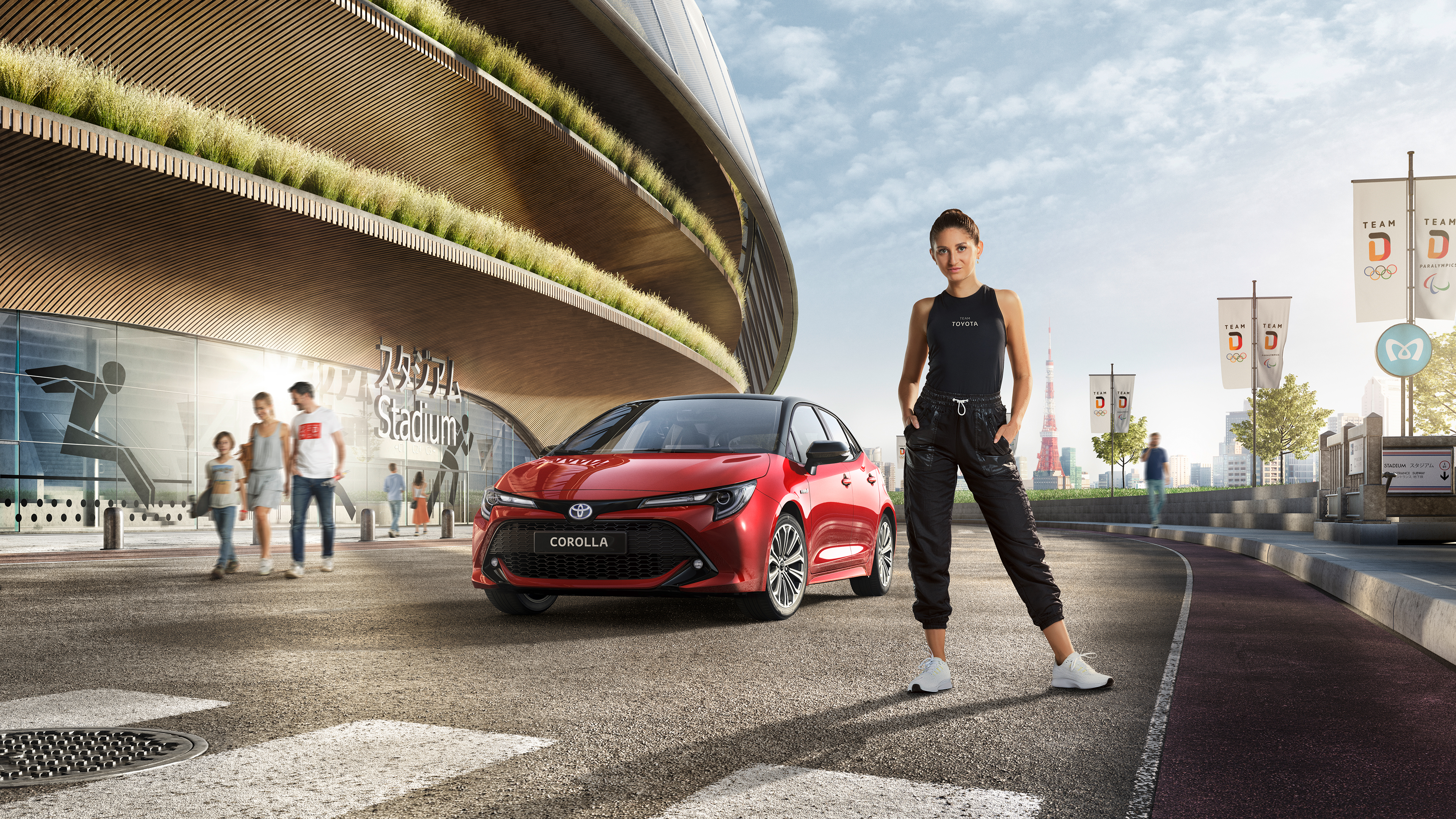 Sportlerin steht vor einem rotem Toyota Corolla am Eingang des Olympiastadions