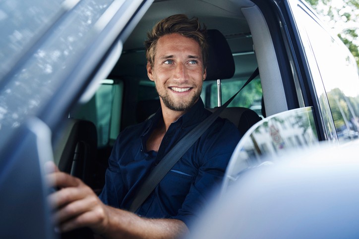 Mann sitz im Auto und schaut aus dem Fenster